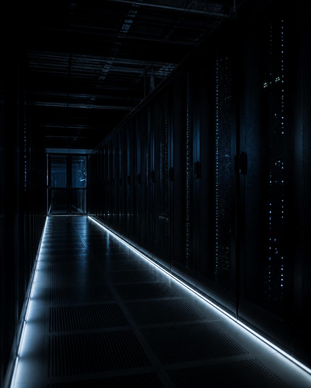 Dark data center aisle lit by thin light lines